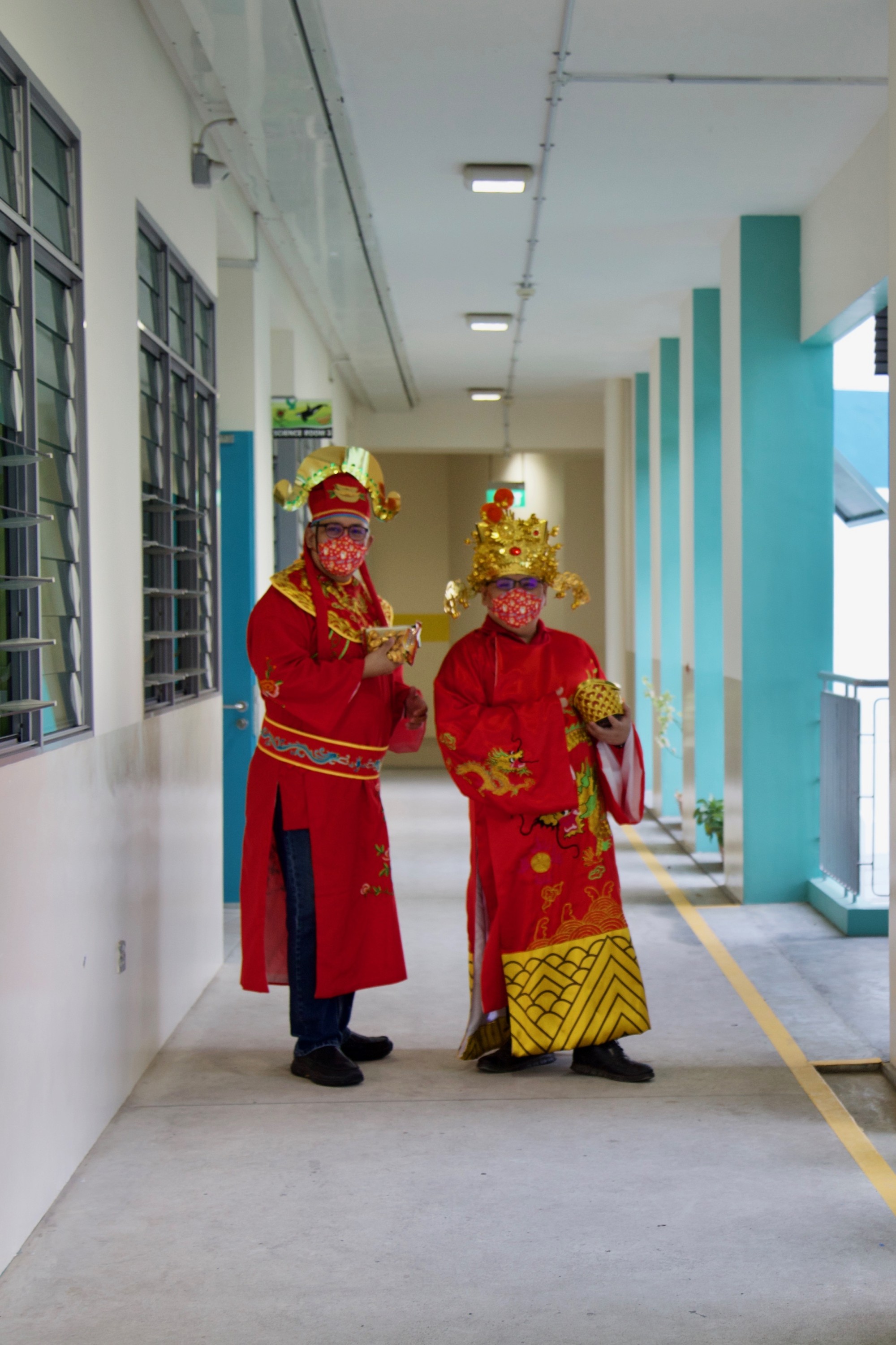 Teachers dressed up as “God of Fortunes” sharing their blessings with students